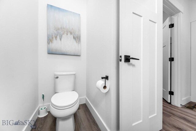1506 Wild Bill Way, Belgrade, MT 59714 - bathroom featuring wood finished floors, baseboards, and toilet
