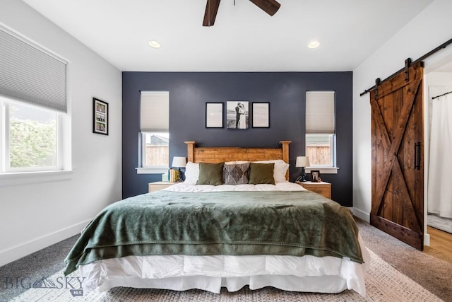 1506 Wild Bill Way, Belgrade, MT 59714 - carpeted bedroom with a barn door, multiple windows, baseboards, recessed lighting, and a ceiling fan