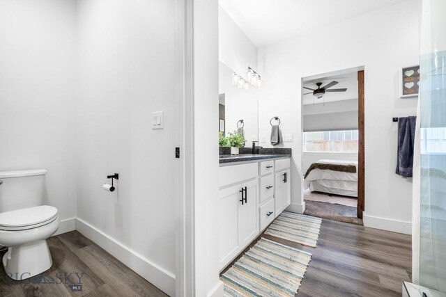 1506 Wild Bill Way, Belgrade, MT 59714 - ensuite bathroom with wood finished floors, baseboards, ceiling fan, and toilet