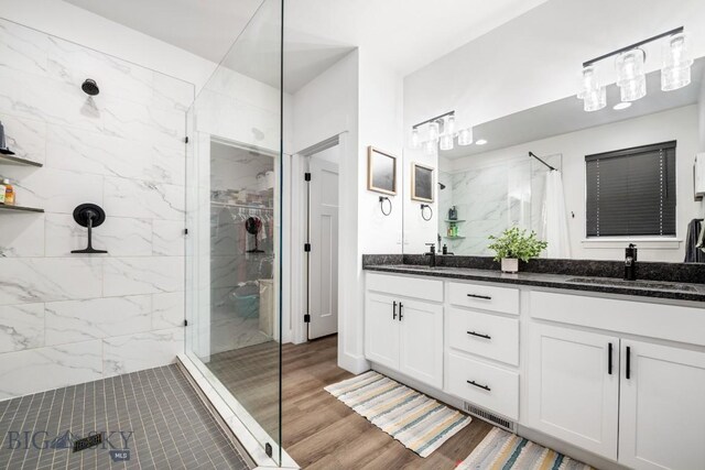 1506 Wild Bill Way, Belgrade, MT 59714 - full bath with a marble finish shower, double vanity, and wood finished floors