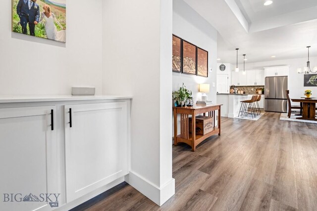 1506 Wild Bill Way, Belgrade, MT 59714 - hallway featuring wood finished floors, recessed lighting, a chandelier, and baseboards