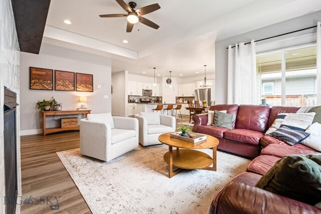 1506 Wild Bill Way, Belgrade, MT 59714 - living room featuring ceiling fan, light wood finished floors, recessed lighting, a fireplace, and baseboards