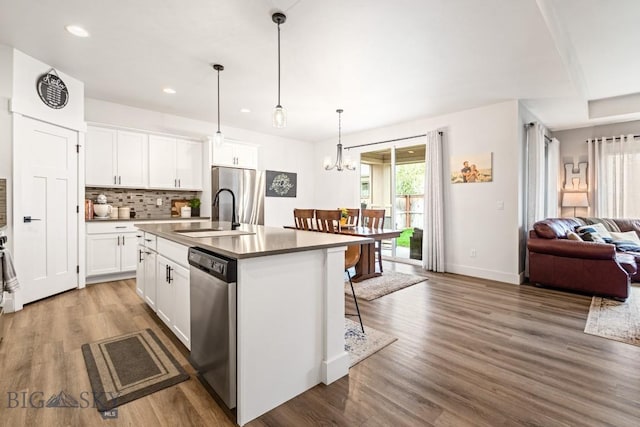1506 Wild Bill Way, Belgrade, MT 59714 - kitchen featuring appliances with stainless steel finishes, a sink, a kitchen island with sink, tasteful backsplash, and open floor plan