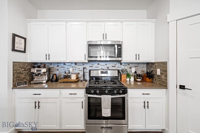 1506 Wild Bill Way, Belgrade, MT 59714 - kitchen featuring stainless steel appliances, white cabinets, tasteful backsplash, and light countertops