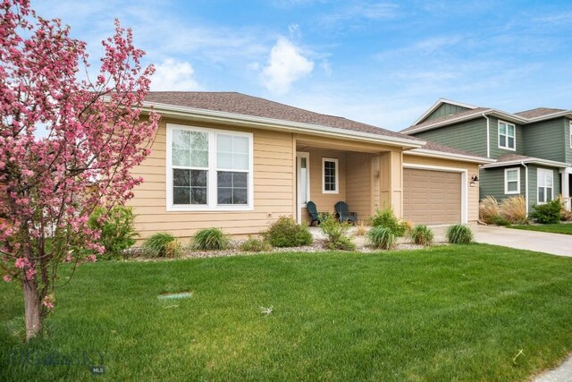 1506 Wild Bill Way, Belgrade, MT 59714 - view of front facade with concrete driveway, a garage, and a front yard