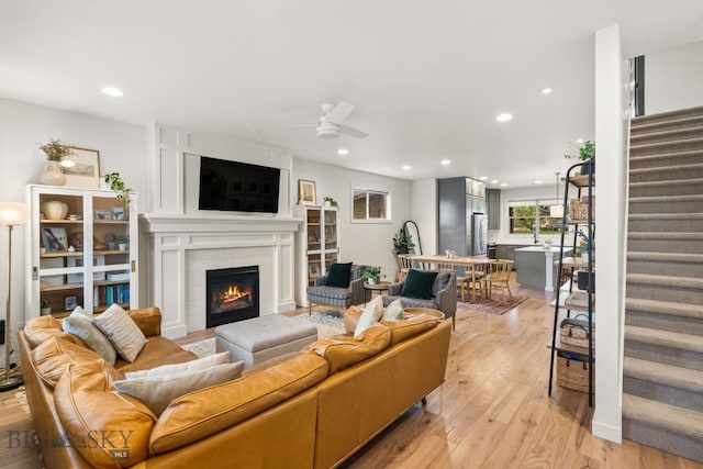 2032 Dennison Ln, Bozeman, MT 59718 - living area with stairway, a ceiling fan, light wood-type flooring, recessed lighting, and a fireplace