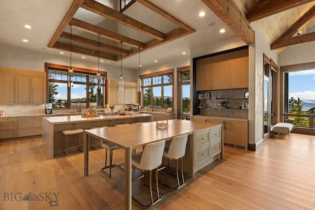 1220 Green Valley Way, Bozeman, MT 59715 - kitchen featuring a spacious island, light countertops, tasteful backsplash, a sink, and beam ceiling