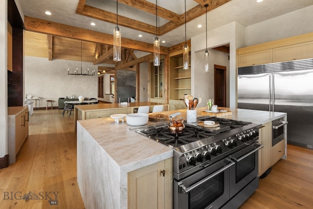 1220 Green Valley Way, Bozeman, MT 59715 - kitchen featuring high quality appliances, a large island, beamed ceiling, light wood-type flooring, and hanging light fixtures