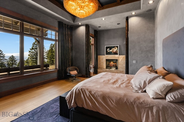 1220 Green Valley Way, Bozeman, MT 59715 - bedroom with wood-type flooring and a warm lit fireplace