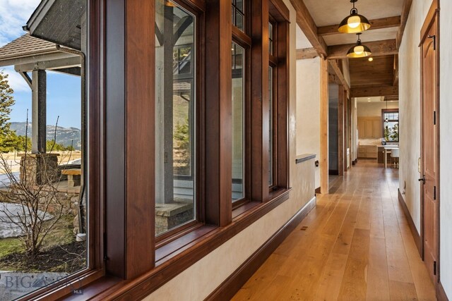 1220 Green Valley Way, Bozeman, MT 59715 - corridor featuring light wood finished floors, beam ceiling, baseboards, and a mountain view