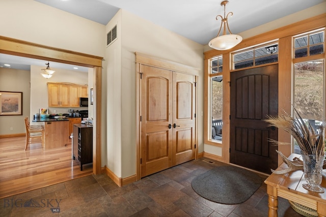 1220 Green Valley Way, Bozeman, MT 59715 - entryway with baseboards and stone tile flooring