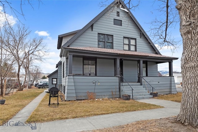view of front facade with covered porch and a front lawn