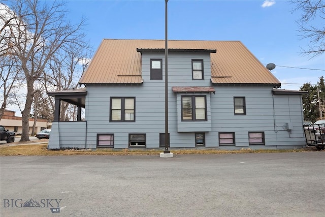 view of side of home with metal roof