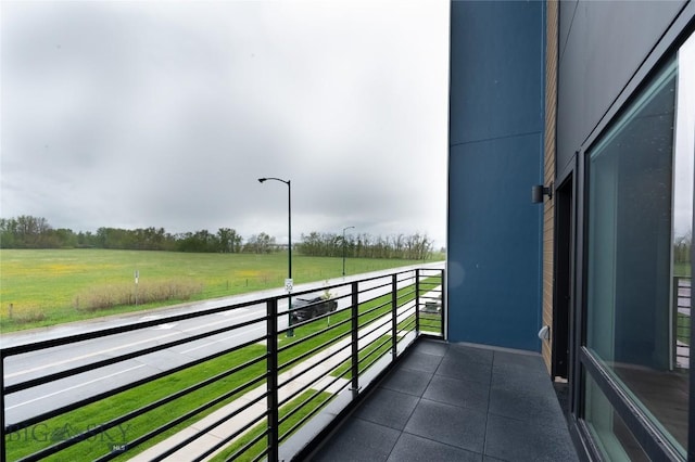 balcony featuring a view of countryside