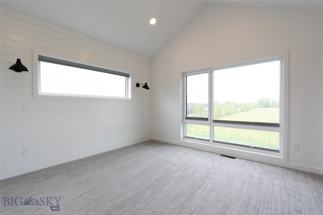 empty room with carpet floors, lofted ceiling, and recessed lighting