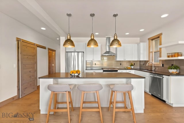 3164 S 15th Ave, Bozeman, MT 59715 - kitchen featuring appliances with stainless steel finishes, wall chimney exhaust hood, a sink, dark countertops, and recessed lighting