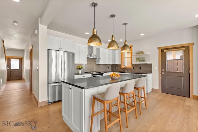 3164 S 15th Ave, Bozeman, MT 59715 - kitchen featuring freestanding refrigerator, baseboards, wall chimney exhaust hood, dark countertops, and recessed lighting