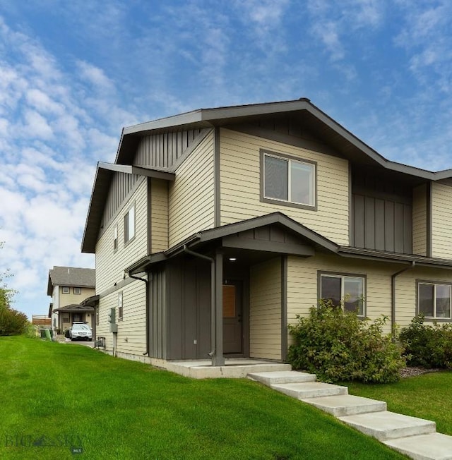 view of front of home with board and batten siding and a front yard