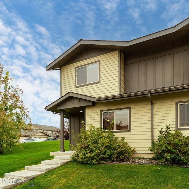 view of front of house with board and batten siding and a front yard