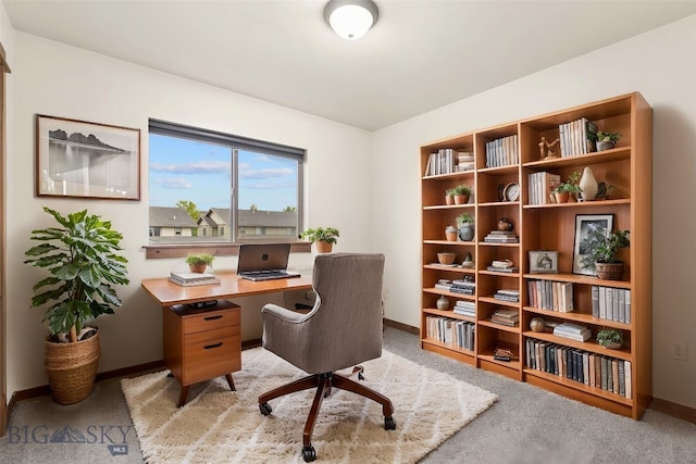 office space featuring baseboards and light colored carpet