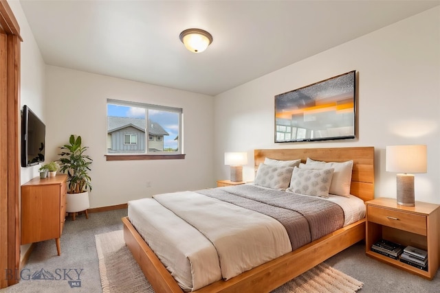 carpeted bedroom featuring baseboards