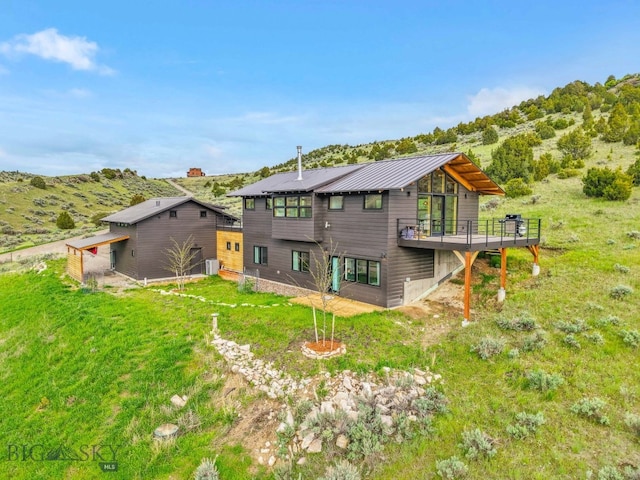 94 Rock Castle Rd, Manhattan, MT 59741 - rear view of property featuring a deck and a metal roof