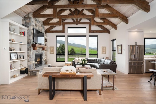17450 Wilson Creek Rd, Gallatin Gateway, MT 59730 - living room featuring a fireplace, high vaulted ceiling, healthy amount of natural light, a wood ceiling with exposed beams, and light wood-style flooring