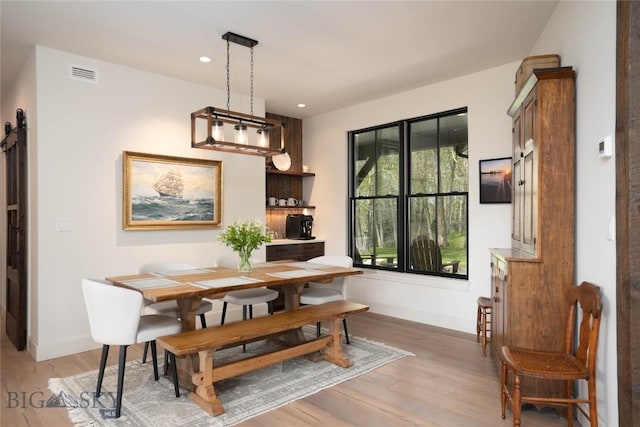 17450 Wilson Creek Rd, Gallatin Gateway, MT 59730 - dining space with light wood finished floors, a barn door, and recessed lighting