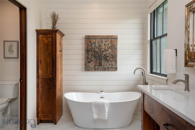 17450 Wilson Creek Rd, Gallatin Gateway, MT 59730 - full bathroom with vanity, a freestanding bath, speckle patterned floor, and wooden walls