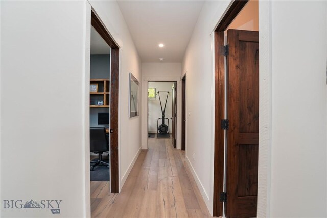 17450 Wilson Creek Rd, Gallatin Gateway, MT 59730 - corridor with light wood finished floors, a desk, and recessed lighting