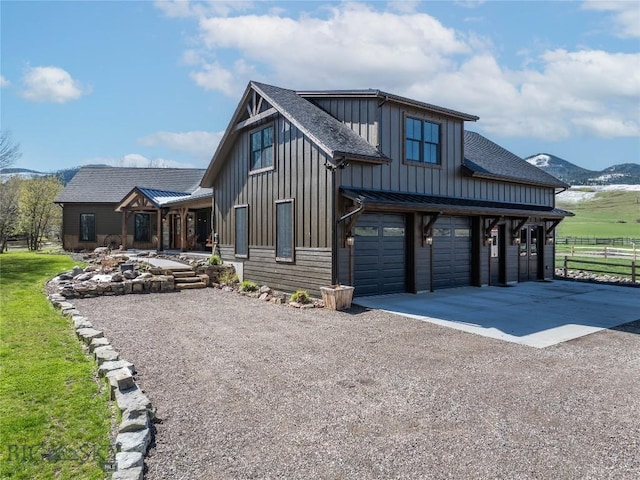 17450 Wilson Creek Rd, Bozeman, MT 59730 - modern farmhouse style home featuring board and batten siding, driveway, a garage, fence, and roof with shingles