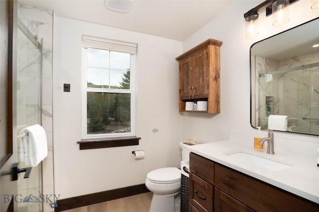 17450 Wilson Creek Rd, Bozeman, MT 59730 - bathroom with a marble finish shower, toilet, vanity, wood finished floors, and baseboards