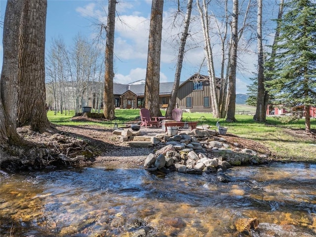 17450 Wilson Creek Rd, Gallatin Gateway, MT 59730 - view of green lawn with an outdoor fire pit