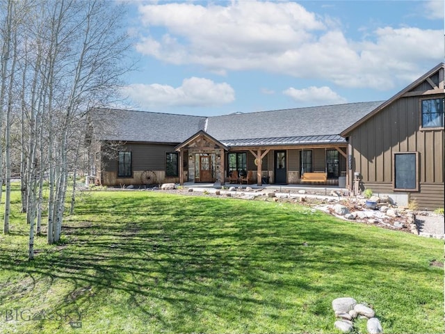 17450 Wilson Creek Rd, Bozeman, MT 59730 - view of front of house with board and batten siding, a porch, a front yard, a standing seam roof, and a shingled roof