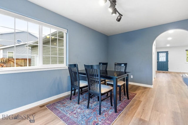 185 Chestnut Grove Ave, Bozeman, MT 59718 - dining space featuring arched walkways, wood finished floors, and baseboards