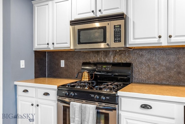 185 Chestnut Grove Ave, Bozeman, MT 59718 - kitchen featuring stainless steel appliances, decorative backsplash, white cabinetry, and light countertops