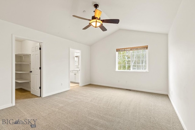 185 Chestnut Grove Ave, Bozeman, MT 59718 - unfurnished bedroom with light carpet, a walk in closet, vaulted ceiling, and baseboards