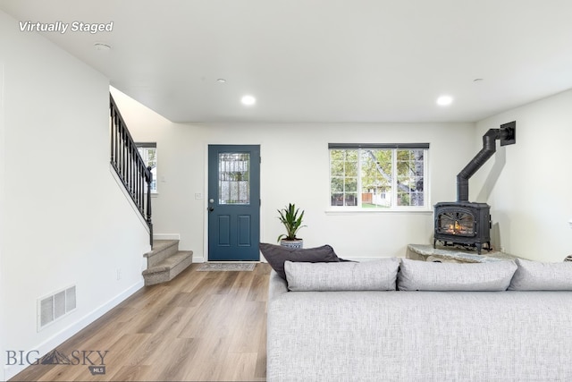 185 Chestnut Grove Ave, Bozeman, MT 59718 - living area with a wood stove, stairs, light wood-style flooring, recessed lighting, and baseboards