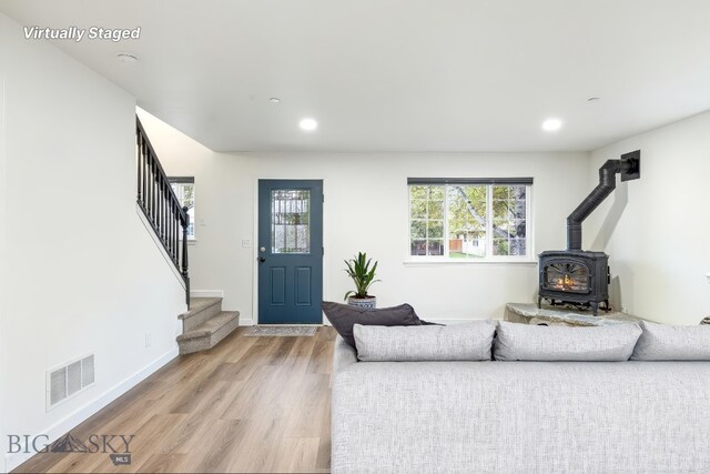 185 Chestnut Grove Ave, Bozeman, MT 59718 - living area featuring a wood stove, healthy amount of natural light, stairway, light wood-type flooring, and recessed lighting