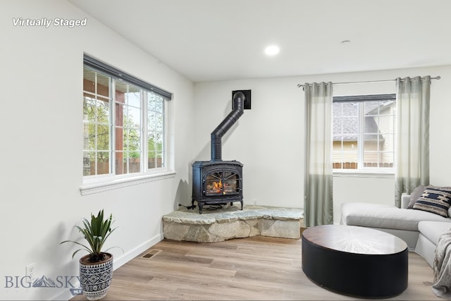 185 Chestnut Grove Ave, Bozeman, MT 59718 - living room with a wood stove, light wood finished floors, baseboards, and recessed lighting