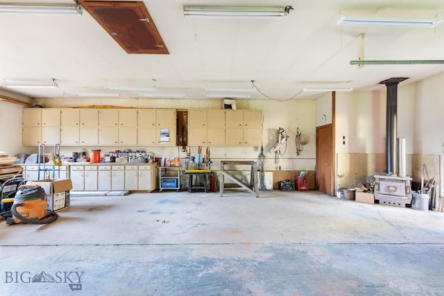 486 Jardine Rd, Jardine, MT 59030 - garage with a workshop area and a wood stove