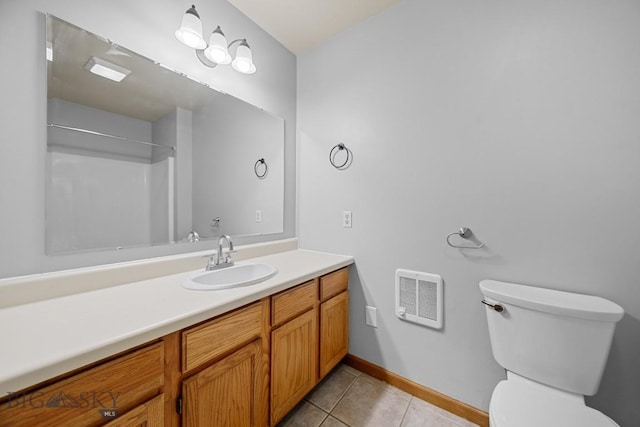 bathroom featuring tile patterned flooring, toilet, heating unit, vanity, and baseboards