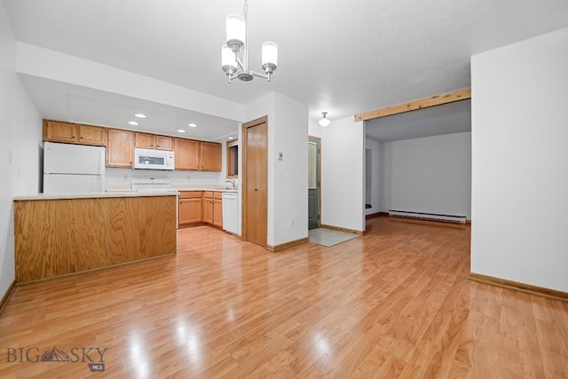 kitchen with white appliances, a baseboard heating unit, light countertops, baseboards, and light wood-style floors