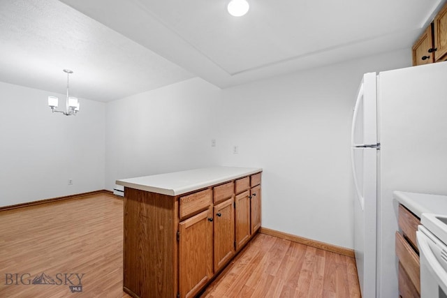 kitchen featuring a peninsula, light wood-type flooring, brown cabinets, baseboards, and a chandelier