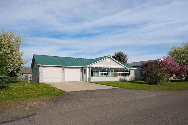 607 N Hoffman St, Belgrade, MT 59714 - ranch-style house featuring driveway, an attached garage, and metal roof