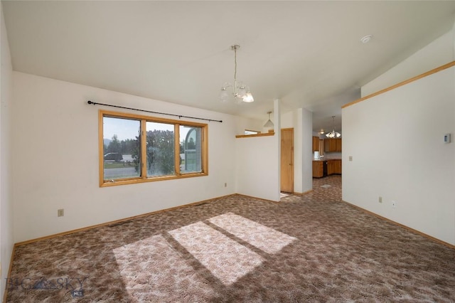 607 N Hoffman St, Belgrade, MT 59714 - empty room featuring a chandelier, carpet floors, and baseboards