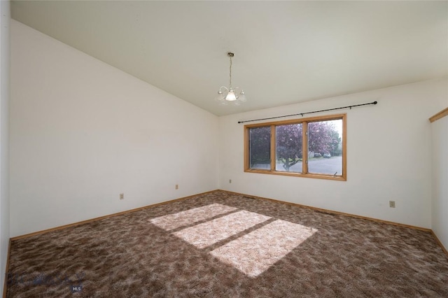 607 N Hoffman St, Belgrade, MT 59714 - spare room featuring carpet floors, vaulted ceiling, baseboards, and a chandelier