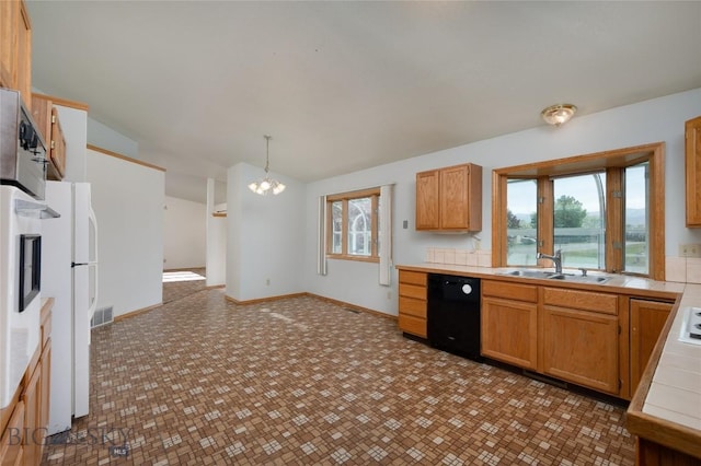 607 N Hoffman St, Belgrade, MT 59714 - kitchen featuring black dishwasher, a sink, a chandelier, lofted ceiling, and healthy amount of natural light