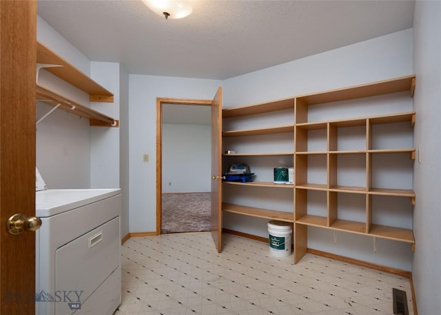 607 N Hoffman St, Belgrade, MT 59714 - laundry area with washer / dryer, light flooring, and baseboards