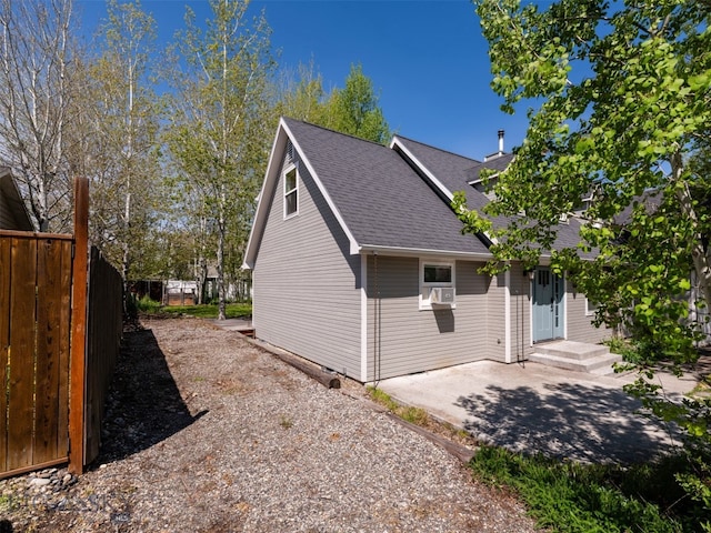 507 Flathead Ave, Bozeman, MT 59718 - view of side of property featuring roof with shingles and a patio area